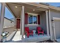 Inviting front porch with comfortable seating, perfect for enjoying the outdoors at 3953 John Ave, Castle Rock, CO 80104
