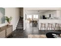 Bright living room showcasing modern tile floors, staircase and seamlessly connecting to the dining area at 4555 Andes St, Denver, CO 80249