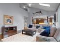 Spacious living room with a cathedral ceiling, large windows, and hardwood floors at 1193 Phipps Ct, Highlands Ranch, CO 80126