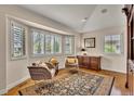 Sun-filled room boasts hardwood floors, neutral paint, plantation shutters, and comfortable seating at 11 Canon Pl, Greenwood Village, CO 80111