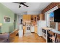 Efficient kitchen boasts wood cabinets, tile backsplash, and an adjacent dining area at 1450 N High St # 3, Denver, CO 80218