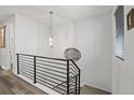 Open staircase featuring modern metal railings and light-colored wood flooring on the upper level at 6728 Mentha Dr, Castle Rock, CO 80108