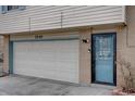 Attached garage and blue front door of home at 1549, showcasing the exterior design at 1549 S Evanston St, Aurora, CO 80012