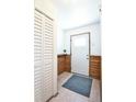 Bright entryway with a closet, wood paneling, and a stylish tiled floor at 1641 S Idalia Cir # F, Aurora, CO 80017