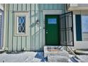 Inviting front entrance featuring a bright green door with a welcome mat at 1641 S Idalia Cir # F, Aurora, CO 80017