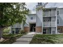 Three-story apartment building with stairs leading to the units and mature trees providing shade at 7395 E Eastman Ave # 202N, Denver, CO 80231