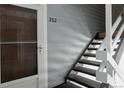 Apartment 202 exterior staircase leading to front door, showcasing neutral siding at 7395 E Eastman Ave # 202N, Denver, CO 80231