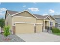 Charming single-Gathering home featuring a three-car garage, stone accents, and a well-manicured front lawn at 17710 E Emilia Dr, Parker, CO 80134