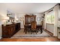 Spacious dining room featuring a large wooden table, antique buffet, and decorative artwork at 1933 Chestnut St, Fort Lupton, CO 80621