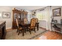 Elegant dining room with ornate wooden furniture, a patterned rug, and bright natural light at 1933 Chestnut St, Fort Lupton, CO 80621