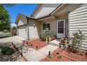 Inviting front porch with decorative planters and flower boxes enhancing the curb appeal at 1933 Chestnut St, Fort Lupton, CO 80621