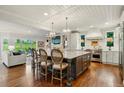 Bright, open-concept kitchen with a large island and seamless flow into the living area at 32 Glenmoor Dr, Englewood, CO 80113