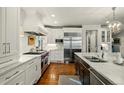 Gourmet kitchen with state-of-the-art stainless steel appliances and custom white cabinetry at 32 Glenmoor Dr, Englewood, CO 80113