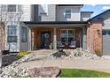 Welcoming front porch with seating, lovely landscaping, and a charming entrance, perfect for greeting guests at 7106 Cerney Cir, Castle Pines, CO 80108