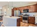 Bright kitchen featuring stainless steel appliances, modern countertops, and sleek cabinetry with an island at 535 Elmhurst Way # A, Highlands Ranch, CO 80129