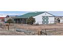 View of a large white barn with a green roof on an expansive rural property at 32350 E 137Th Way, Brighton, CO 80603