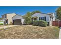 Inviting single-story home with a two-car garage, tidy landscaping, and a cozy front porch at 4600 Dillon St, Denver, CO 80239