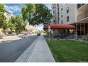 Street view of the condo building, featuring sidewalk, street, and partial view of the building at 2 Adams St # 1504, Denver, CO 80206