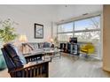 Comfortable living room with large windows, a stylish sofa, and modern decor for a relaxing atmosphere at 2958 Syracuse St # 204, Denver, CO 80238