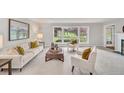 Bright living room with large windows offering picturesque views and neutral decor at 10 Martin Ln, Cherry Hills Village, CO 80113