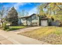Attractive home with attached garage, a well-manicured lawn and mature landscaping at 12829 E Oregon Dr, Aurora, CO 80012