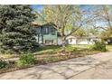 A cozy home featuring mature trees and a well kept lawn, perfect for families at 12829 E Oregon Dr, Aurora, CO 80012