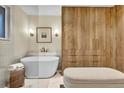 Modern bathroom boasts a freestanding tub, natural wood accents and sleek fixtures, creating a spa-like retreat at 4262 E Fremont Pl, Centennial, CO 80122