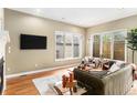 Sun-filled living room featuring hardwood floors, large windows, and stylish furnishings at 529 Uinta Way, Denver, CO 80230
