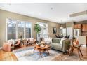 Bright and airy living room featuring hardwood floors, and large windows with views of the landscaped yard at 529 Uinta Way, Denver, CO 80230