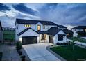 Striking two-story modern farmhouse featuring a black roof, white siding, and a three-car garage at 39405 Stockton Cir, Elizabeth, CO 80107