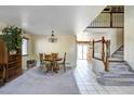 View of the carpeted living area, staircase, and dining space with lots of natural light at 4863 Quail Ct, Frederick, CO 80504