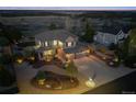 Aerial view of a beautifully landscaped home with a spacious yard and inviting curb appeal at twilight at 1302 Milbury St, Castle Rock, CO 80104