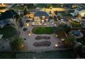 Aerial view of an expansive backyard featuring a patio, lush lawn, and meticulously designed landscaping at 1302 Milbury St, Castle Rock, CO 80104