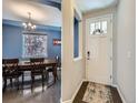 Dining room featuring a large wooden table, stylish chandelier, and lots of natural light at 30 Sun Up Ct, Erie, CO 80516