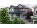 Charming two-story home with a cozy front porch, manicured landscaping, and attractive exterior paint scheme at 30 Sun Up Ct, Erie, CO 80516