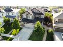 A stunning two-story home boasts a large driveway, two-car garage, and meticulously maintained landscaping at 30 Sun Up Ct, Erie, CO 80516