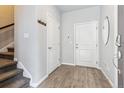 Welcoming entryway with hardwood floors, coat hooks, and access to the staircase at 4260 E Warren Ave # 5, Denver, CO 80222