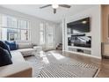 Stylish living room with a large TV, modern furniture, and a sliding door to the outside at 4260 E Warren Ave # 5, Denver, CO 80222