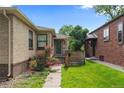 Charming entrance with brick facade, garden, and inviting walkway to the front door at 1540 Filbert Ct, Denver, CO 80220