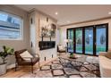 Living room features a fireplace, large windows and access to backyard at 291 S Franklin St, Denver, CO 80209