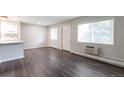 Bright and airy room with wood floors, white trim, and a large window at 5770 E Warren Ave # 206, Denver, CO 80222