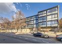 Modern condo building with parking and landscaping at 1050 N Corona St # 215, Denver, CO 80218