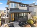 Charming two-story home featuring a modern design, brick accents, and a welcoming yellow front door at 1730 W 67Th Ave, Denver, CO 80221