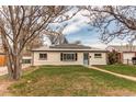 Charming home with solar panels and a light blue front door at 9280 Russell Way, Thornton, CO 80229
