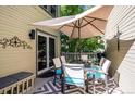 Deck with outdoor dining set, umbrella, and gray patterned rug at 6324 S Grape Ct, Centennial, CO 80121