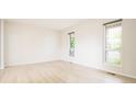Bright and airy living room featuring wood flooring and large windows offering plenty of natural light at 4760 S Wright Way, Morrison, CO 80465