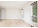 Bright and airy living room featuring wood flooring and large windows offering plenty of natural light at 4760 S Wright Way, Morrison, CO 80465