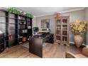 Home office with built-in bookshelves, stylish decor, and a large desk for productive work from home at 20182 E Maplewood Pl, Centennial, CO 80016