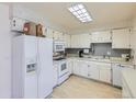 Functional kitchen with white appliances and ample cabinet space at 1576 S Ursula Ct, Aurora, CO 80012