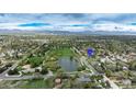 Overhead view showcasing the property's location near a scenic park, pond, and the distant mountains at 6735 W 2Nd Ave, Lakewood, CO 80226